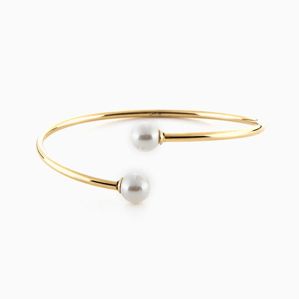 Bracciale rigido dorato con perle bianche